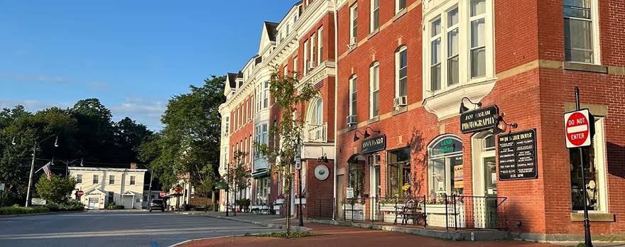 Sunlit brick storefronts along Main Street in Pawling, New York
